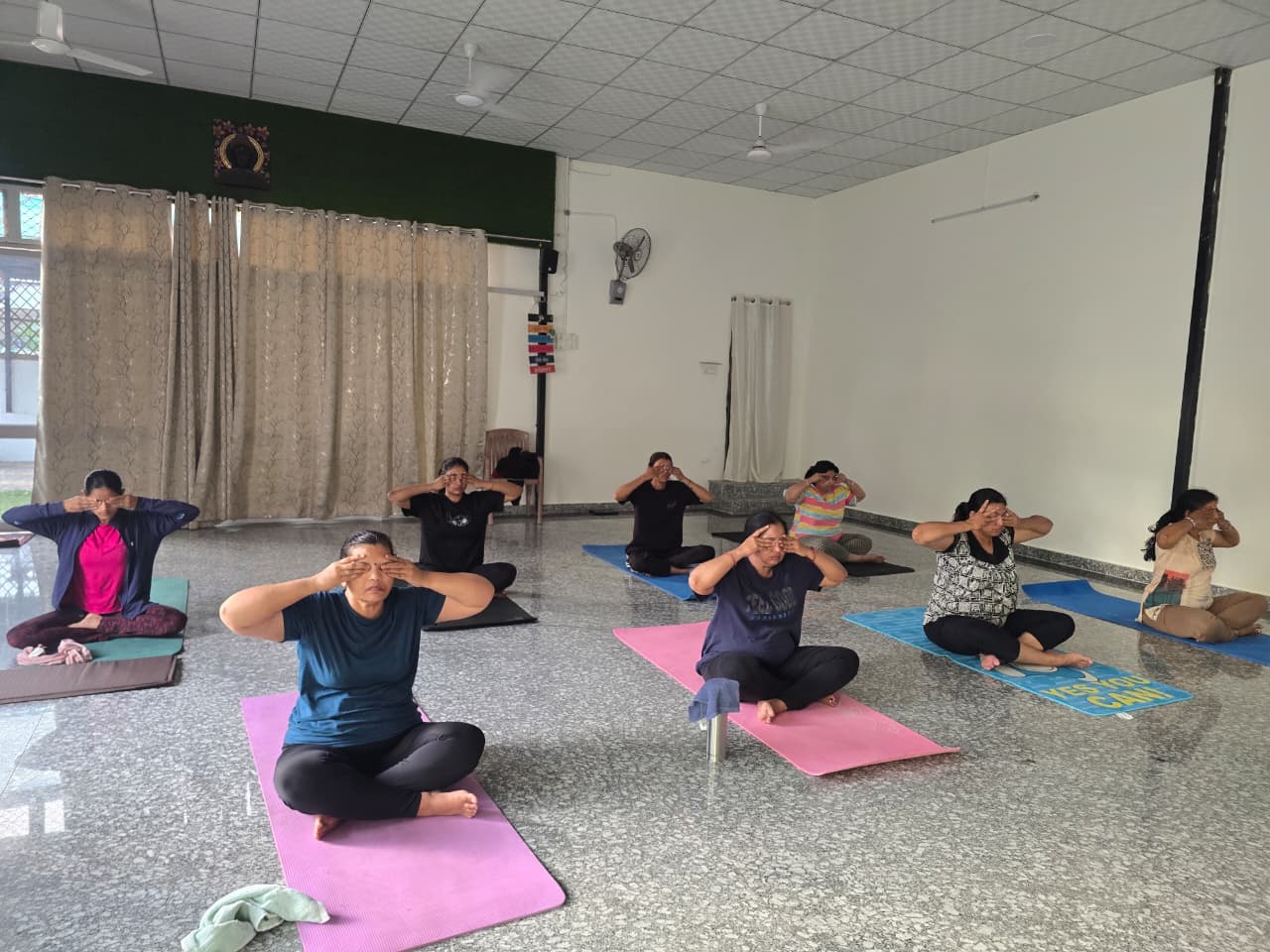 Group breathing practice at Raj Yogashala