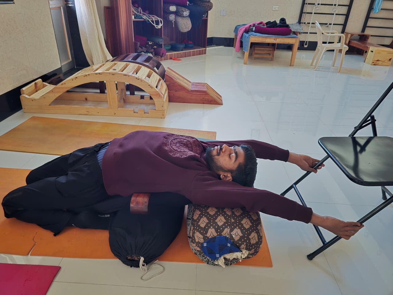 Restorative yoga practice with props at Raj Yogashala